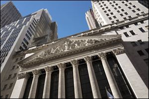 This  Dec. 21, 2016, file photo shows the New York Stock Exchange. Global stocks are mostly higher Tuesday, though US stocks fell with losses to banks and smaller companies.