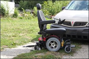 A wheelchair near the scene of a shooting at South Avenue and Spencer Street in Toledo on September 14. Three people were indicted Wednesday on charges stemming from a drive-by shooting in which a woman in a wheelchair was an unintended victim.