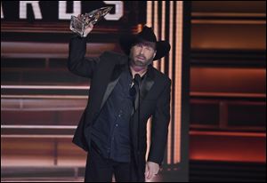 Garth Brooks accepts the award for entertainer of the year at the 51st annual CMA Awards.