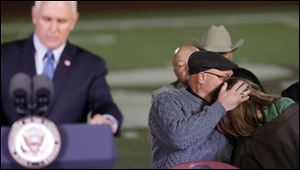 Sutherland Springs First Baptist Church Pastor Frank Pomeroy, center, comforts his wife Sherri, right, as Vice President Mike Pence, left, speaks during a prayer vigil for the victims of the Sutherland Springs First Baptist Church shooting Wednesday, Nov. 8.