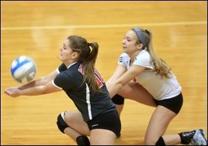 Bedford's Katrina Reynolds, left, and Breeanna Long go for the ball during Thursday's regional championship match against Livonia Churchill.