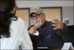 Air Force veteran Bill  Morrison of Monroe, Mich., is interviewed by Nathan Rizoy, 18, at the Penta Career Center Friday, November 10.