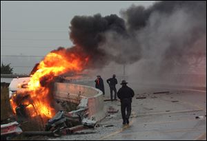 Police arrive on the scene of a crashed semi truck engulfed in flames on Saturday, where State Route 53 South splits from US 20 West in Fremont, Ohio.