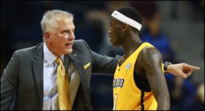Toledo head coach Tod Kowalczyk gives instructions to guard Marreon Jackson.