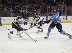 Toledo's Christian Hilbrich (8) takes a shot during the home opener for the Toledo Walleye against the Quad City Mallards  at the Huntington Center in Toledo on Oct. 21.