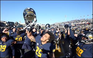 The University of Toledo football team celebrates defeating Western Michigan 37-10 on Friday at the Glass Bowl and earned a Mid-American Conference West title and a trip to the MAC championship game for the first time since 2004.