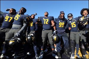 The University of Toledo football team celebrates defeating Western Michigan 37-10 on Friday at the Glass Bowl and earned a Mid-American Conference West title and a trip to the MAC championship game for the first time since 2004.