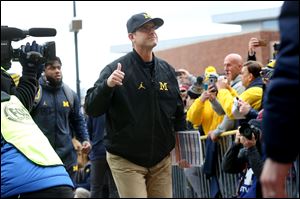 Michigan head coach Jim Harbaugh signed 16 recruits on Wednesday with the Wolverines expected to add more in the February signing period.