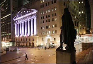 In this Wednesday, Oct. 8, 2014, file photo, a statue of George Washington stands near the New York Stock Exchange, in background. 