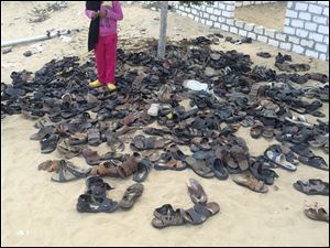 Discarded shoes of victims remain outside Al-Rawda Mosque in Bir al-Abd northern Sinai, Egypt. a day after attackers killed hundreds of worshippers.
