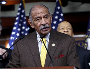 Rep. John Conyers speaks at a news conference. House Minority Leader Nancy Pelosi, the top Democrat in the House, said Thursday that Conyers should resign, saying sexual harassment accusations made against him are 