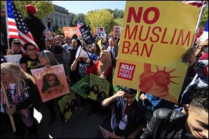Protesters gather at a rally in Washington. The Supreme Court is allowing the Trump administration to fully enforce a ban on travel to the United States by residents of six mostly Muslim countries. 