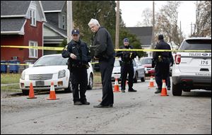 Toledo police investigate a shooting in the 1400 block of Vance Street Tuesday December 5, 2017 in Toledo. 