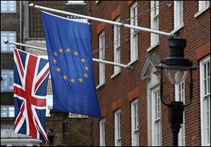 The European Union and British Union flags fly in Westminster in London.