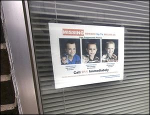 A sign of the boys on the window at the Jeffrey A. Robichaud, D.D.S. dental practice in Morenci, Mich., on Friday. Three bodies discovered in Montana are a possible lead in the case of the three Skelton boys, of Morenci, who have been missing since 2010.
