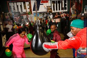 Oshae Jones, left, Nashay Bradford, 15, and Otha Jones III, 17, demonstrate their technique at Soul City Boxing.