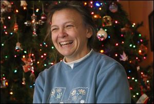 Peggie Avers sits in front of the Christmas tree at her home in Elmore on December 18. Avers suffered a serious injury around Christmas last year and spent the holidays in the hospital.