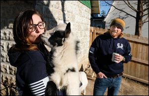 Amanda Held with her goat Loomis and her husband Justin Held Friday, December 8, in Grand Rapids, Ohio. The couple has three goats and are being told by the city they have to get rid of them.