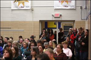 People stand in the doorway to listen during the Washington Local school board meeting Wednesday.