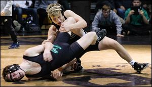Genoa’s Julian Sanchez, top, defeats Delta’s Cole Mattin for the championship in the 126-pound weight class at the Perrysburg Invitational Tournament on Saturday.