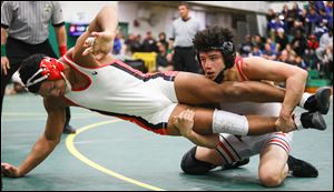 Wauseon's Sandro Ramirez takes down Elyria's Farouq Muhammed 4-1 in the 152-pound championship match during the Maumee Bay Classic wrestling tournament .