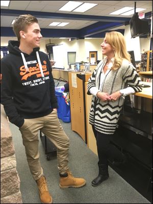 Erica Scharer, 47, of Ottawa Hills and Djimmer Riemersma, 17, of Vries, Netherlands, chat before the start of a meeting Tuesday at Perrysburg High School for Toledo-area families who are interested in hosting foreign exchange students. Ms. Scharer is hosting him at her home.