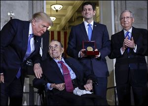 President Trump speaks to former Sen. Bob Dole during a Congressional Gold Medal ceremony honoring Mr. Dole on Wednesday.