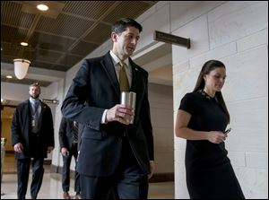 House Speaker Paul Ryan of Wis., center, accompanied by his Press Secretary AshLee Strong, right, walks to the Capitol Building from the Capitol Visitor's Center, Thursday, Jan. 18.