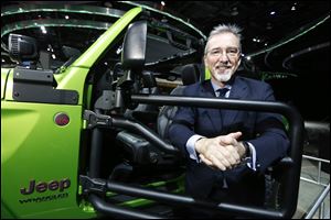 Pietro Gorlier, head of Mopar, next to a Mopar-outfitted Jeep Wrangler at the North American International Auto Show media preview day, in Detroit, Michigan on January 16, 2018.