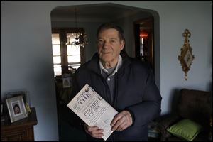 Rolland Stieben, 86, holds a keepsake edition of The Blade celebrating the 30th anniversary of the Blizzard of 1978 at his home in Toledo. Mr. Stieben said the most memorable part of dealing with the blizzard was helping his five children deliver The Blade the afternoon the weather struck. In all, the family made sure 66 people received their newspapers. 