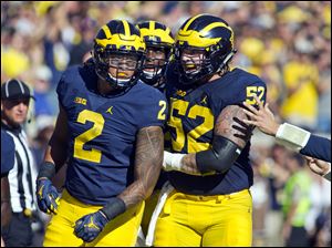 The departure of Mason Cole, right, leaves a hole on Michigan's offensive line.