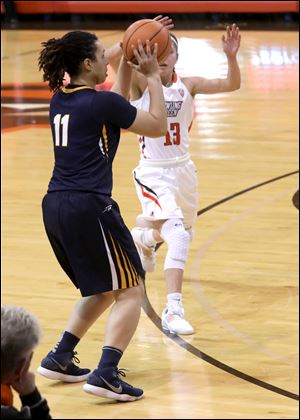 Toledo's Jay Bravo-Harriott aims under pressure from BGSU's Sydney Lambert during basketball game at the Stroh Center in Bowling Green, Ohio. Bravo-Harriott was the high scorer with 27 points.