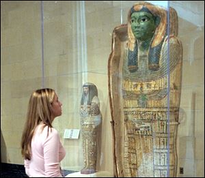 Jessica Buckenmeyer, then a senior from Swanton HS, looks over one of the mummy case displays at the Art Museum. 