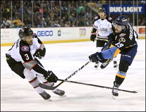 Brampton's Matt Petgrave, left, defends as Toledo's Erik Bradford takes a shot on goal during Saturday's ECHL game at the Huntington Center in downtown Toledo.