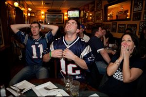 New England Patriots fans watch Super Bowl XLVI on February 5, 2012 in Boston, Massachusetts. The New York Giants defeated the Patriots 21-17.