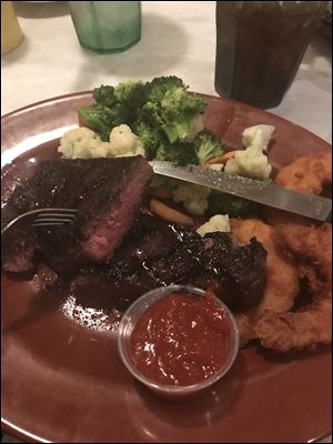 New York Strip steak with breaded shrimp ($23.99) at Ahmed's Steakhouse.