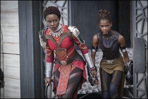 Lupita Nyong'o, left, and Letitia Wright appear in a scene from Marvel Studios' 'Black Panther.'