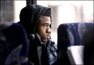 Freshman guard Dwayne Rose, Jr., looks out the window of the bus before it embarks for the arena on game day.