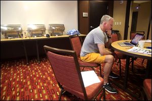 Head coach Tod Kowalczyk studies film before breakfast at the team hotel before the team's Feb. 17 game vs. Ball State.