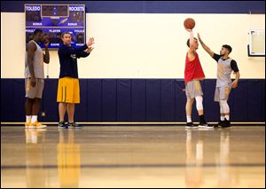 Associate head coach Jason Kalsow, second from left, leads part of the men's basketball practice at the University of Toledo on Feb. 16. Later that day, UT departed for its road game at Ball State on Feb. 17.