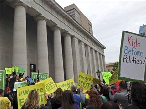 In this file photo, hundreds of supporters of Ohio's largest online charter school, the Electronic Classroom of Tomorrow or ECOT, participate in a Tuesday, May 9, 2017, rally outside the Statehouse in Columbus, Ohio.