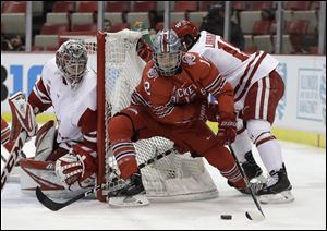 Ohio State forward Miguel Fidler controls the puck next to Wisconsin goalie Jack Berry during last year's Big Ten tournament.