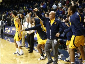Whitmer players and coaches celebrate Thursday's 40-36 district semifinal win over St. Francis. 