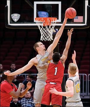 Toledo's Luke Knapke blocks a shot by Miami guard Nike Sibande.