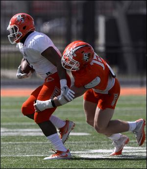 Andrew Clair is tackled by Brandon Perce during the Bowling Green State University spring football game. Clair stepped into a starting role as a true freshman a year ago.
