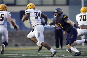 Nevone McCrimmon (34) is taken down by Tyler Taafe during the University of Toledo spring game.