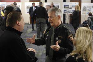 Jay Merritt, left, talks with Lucas County Sheriff John Tharp during an open information session on a proposed new Lucas County jail on Feb. 7.