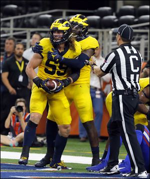 Michigan linebacker Noah Furbush (59) and linebacker Mike McCray (9) celebrate a fumble-recovery by Furbush for a touchdown in the end zone against Florida last season. Furbush is gearing up for his final season with the Wolverines.