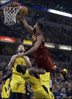 Cleveland Cavaliers' Tristan Thompson heads to the basket as Indiana Pacers' Domantas Sabonis (11) and Victor Oladipo defend.