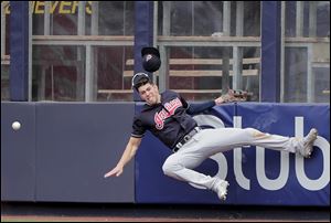 Cleveland Indians center fielder Bradley Zimmer slams into the wall while trying to catch a ball hit deep by New York Yankees' Austin Romine.